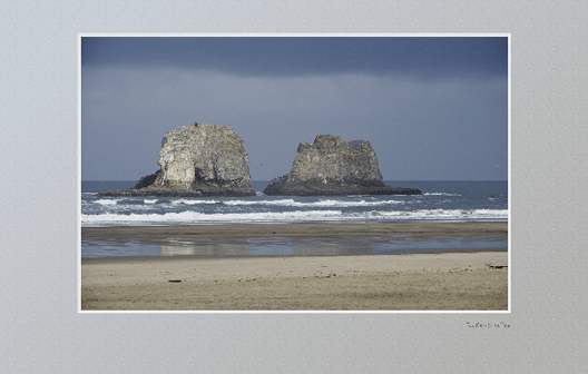 Twin Rocks in surf, during rain storm